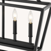 Detail | close view of two candle sockets, bulbs, and the cage's corner joinery