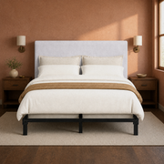 Clay room | Front view of the upholstered headboard against a clay wall with matching sconces and dark nightstands