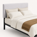 Detail | Close view of the padded velvet headboard surface, rounded corners, bedding, and frame edge