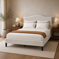 Room 1 angle | Three-quarter bedroom view showing the upholstered side rail, curved headboard, black legs, and both nightstands