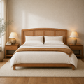 In a room | Straight-on arched walnut headboard in a bright bedroom with sheer curtains, an olive plant, and warm ceramic lamps