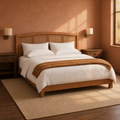 Room three corner | Same clay-toned bedroom from the corner, with a ceramic bowl, books, and a small potted plant