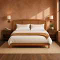 Room three | Straight-on headboard in a clay-toned bedroom with brass wall sconces and dark wood nightstands