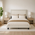 Airy room | Straight-on bed in a bright room with oak nightstands, plant, and rug