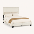 Studio | Three-quarter studio view of the upholstered bed with dark legs and nailhead trim