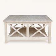 Front | unfinished square rubberwood coffee table with open shelf and crossed braces on a plain studio background