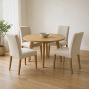 In a room | all four matching chairs at a warm oak dining room's round table, soft morning sidelight from the left