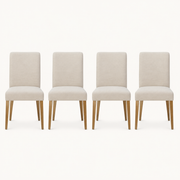Front | all four matching chairs centered on paper, beige linen weave and the tapered wood legs visible