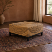 Second room | square brown wicker coffee table in a warm clay living room