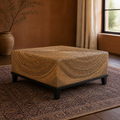 Second room angle | three-quarter view of the wicker coffee table in the clay living room