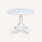 Front | white round table centered on paper, scalloped rim and four curved feet facing the camera