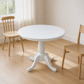 Angle | same room, table at a three-quarter so the turned pedestal and scalloped top both read