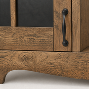 Wood-grain detail | close view of brown wood grain and the curved apron beside a black iron pull