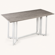 Closer | detail of the wood-grain top edge, hinge line, and white square-tube gate legs on paper
