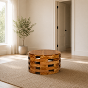 In scale | compact round wood coffee table on a plain rug beside an uncropped floor-to-ceiling doorway