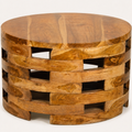 Close detail | warm wood grain, knots, and lighter streaks across the coffee table top and upper rim