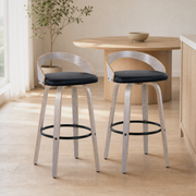In a kitchen | both stools stand at a wood island, light gray-washed frames with black faux-leather seats, morning light through sheer curtains