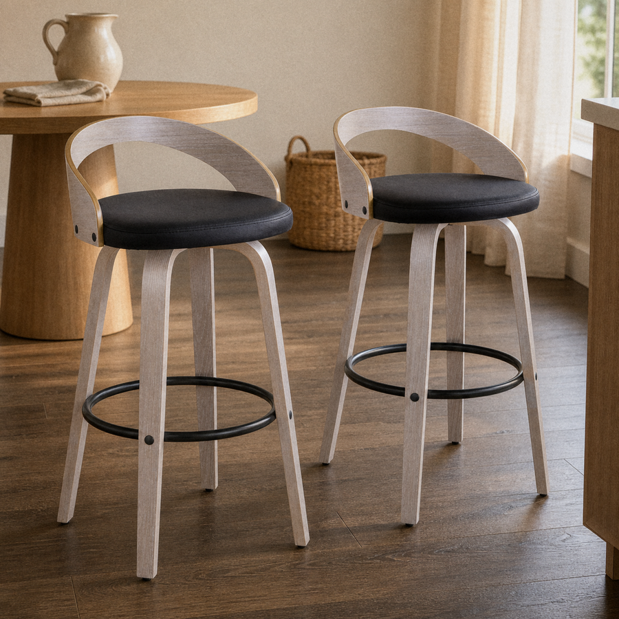 In a dining nook | both stools by a round table set with a stoneware pitcher and linen napkin, warm afternoon light