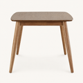 Front | Natural rectangular table centered on paper, four tapered legs and apron facing camera