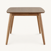 Front | Natural rectangular table centered on paper, four tapered legs and apron facing camera