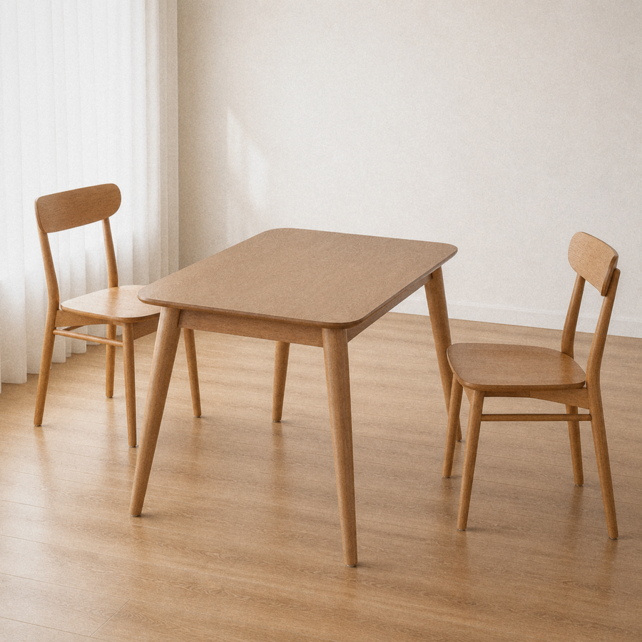 Angle | same dining room, table at a three-quarter so the top, apron, and splayed tapered legs all read