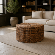 Green library | woven rattan coffee table before an ivory sofa on a plain cream rug