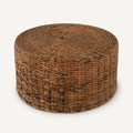 Three-quarter | round woven rattan coffee table showing the coiled top and cylindrical body