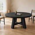 In a room | round black trestle dining table in a flax dining room, bright soft midday light from the left