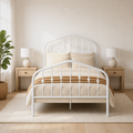 Airy room | White spindle bed centered in a bright room with light wood nightstands and a leafy plant
