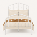 Detail | Close studio view of the arched headboard, turned spindle accents, and matching footboard