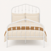 Detail | Close studio view of the arched headboard, turned spindle accents, and matching footboard