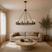 Living room | the chandelier centered above a round travertine coffee table