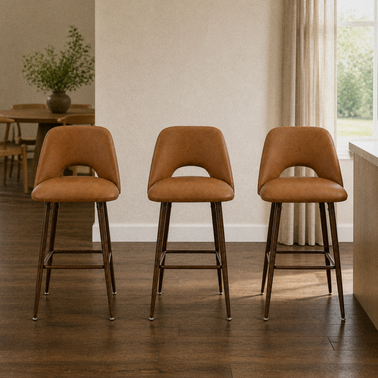 In a room | all three matching counter stools at a plaster dining room's kitchen island edge, low golden afternoon light from the right