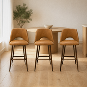 In a room | all three stools at a pale-oak dining room's kitchen island edge, soft morning sidelight from the left