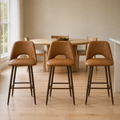 In a room | all three stools at a flax dining room's kitchen island edge, bright soft midday light from the left