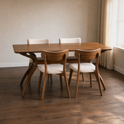 Second room | table and all four chairs in a warm plaster dining room, golden afternoon light