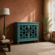 Terracotta room | teal-green lattice-door cabinet on a plain oatmeal rug beside a walnut table, lamp and plants