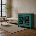 Greige loft | teal-green lattice-door cabinet beside a cream sofa, round steel table, plant and plain rug
