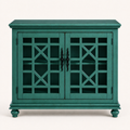 Front studio | antique teal-green cabinet with two closed geometric lattice doors, dark ornate pulls, molded top and four turned bun feet