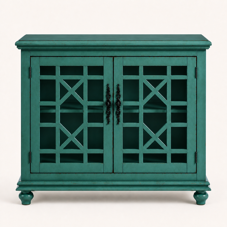 Front studio | antique teal-green cabinet with two closed geometric lattice doors, dark ornate pulls, molded top and four turned bun feet