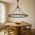 In a room | black wagon-wheel chandelier hanging over a round oak table
