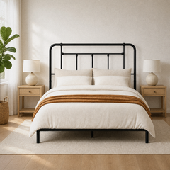 Room 2 | Bright bedroom view with the black headboard, oak nightstands, and a leafy plant