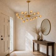 In a room | the chandelier hanging in a warm entryway above a console table