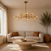 In a room | the chandelier over a travertine coffee table in a sunlit living room