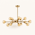 Front | the gold sputnik chandelier centered on white, all 15 amber glass globes and the rigid rod visible