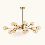 Front | the gold sputnik chandelier centered on white, all 15 amber glass globes and the rigid rod visible