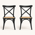 Front | both black cross-back rattan side chairs centered on paper, matte black frame and natural rattan seats visible