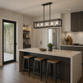 Scale | Matte black five-light linear chandelier above a kitchen island beside a full-height door