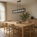 Room 1 angle | Angled dining-room view of the matte black five-light linear chandelier