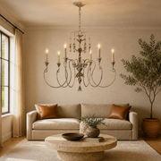 Living room | the chandelier centered above a round travertine coffee table